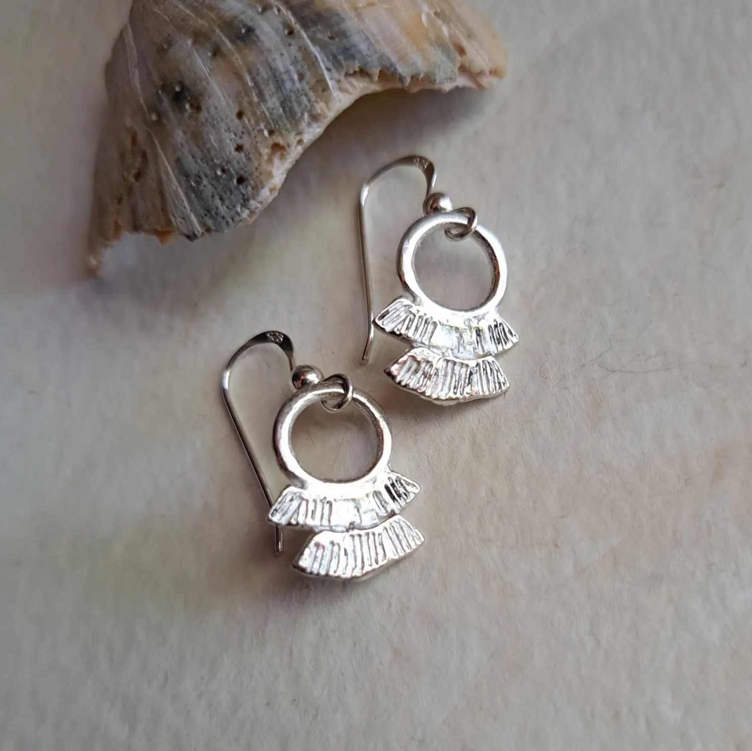 Silver Kriya Davis earrings on a neutral background
