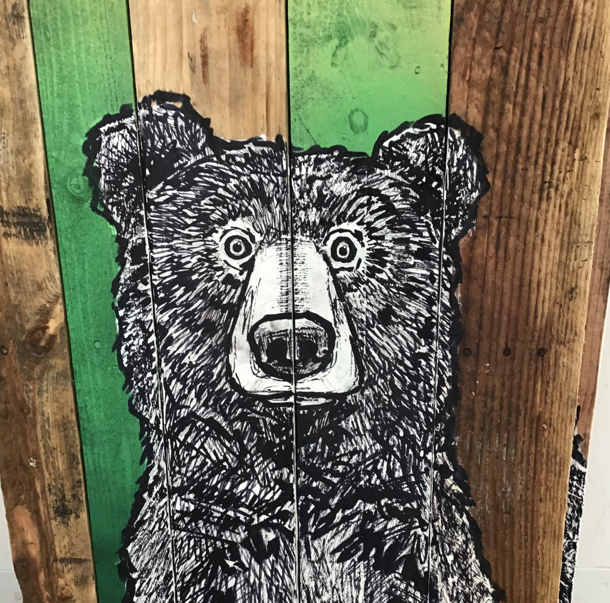 Creighton Studios sketched, cartoon-style of a bear on a rustic striped wood background illustration of a